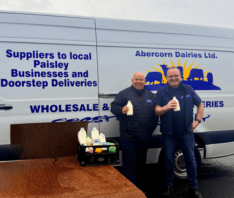 Staff standing in front of Abercorn Dairies van